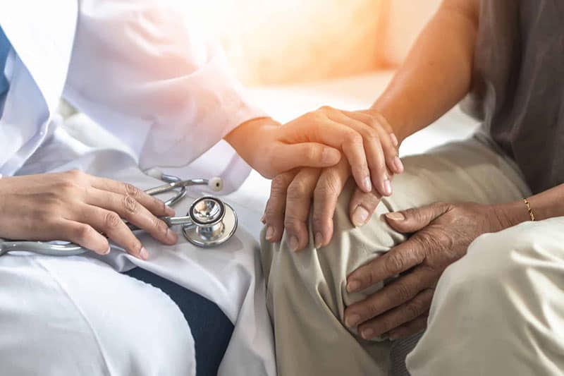doctor holds patient hand