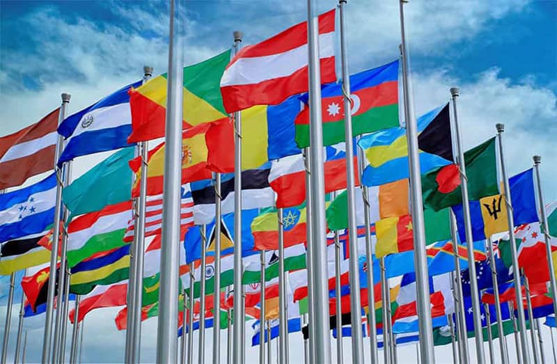 various countries national flags hang on the pipes